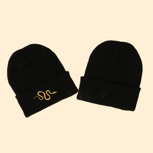 Black knitted beanie hat with yellow snake embroidery detail for winter warmth