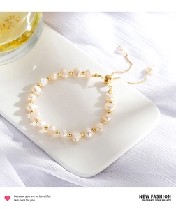 Detail of baroque pearl bracelet with 14K gold-plated beads and adjustable pull cord