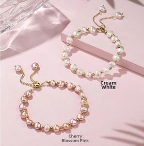 Detail of 14K gold plated Baroque pearl bracelets in creamy white and sakura pink colors