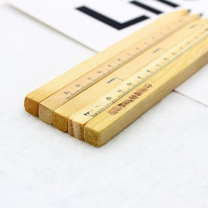 Macro detail of natural wooden ballpoint pen with 14cm scale and clear wood grain texture