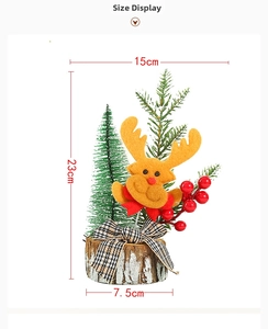 Detailed view of mini Christmas tree on wood base with reindeer head and red berries