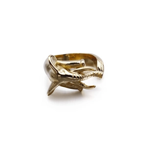 Vintage elephant trunk ring in gold finish with punk style aesthetic on white background