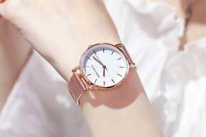 Close-up of Rose Gold Milanese Mesh Strap and Minimalist White Dial Watch on a Wrist