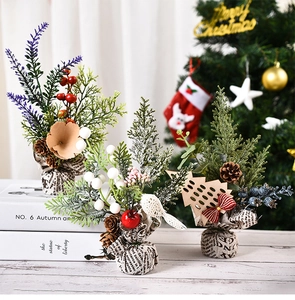 Close-up of three mini Christmas artificial plants in rustic newspaper burlap bases