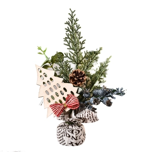 Mini Christmas tree desktop decor with berries and pine cones on a white background