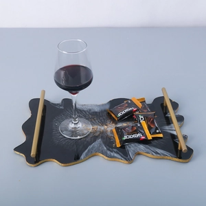 Detailed top view of irregular marble resin tray with gold foil accents and metal handles