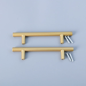 Detail view of T-bar gold sandblasted cabinet handles with matching mounting screws