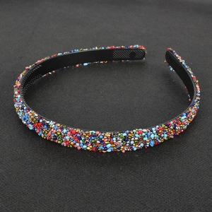 Detail view of colorful handcrafted beads and non-slip inner teeth on retro headband