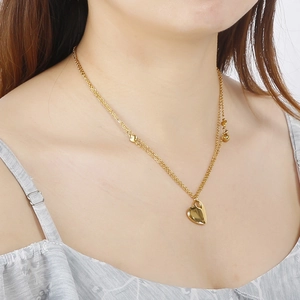 18K gold plated stainless steel layered heart necklace worn on a female model