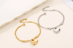 Close-up of gold and silver double-layer chain bracelets with heart pendants