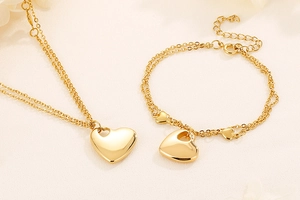 Detailed view of dual-layer gold plated stainless steel heart necklace and bracelet set
