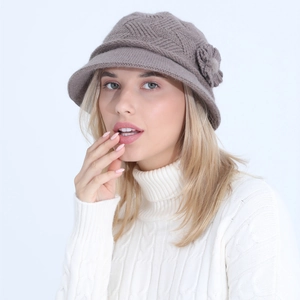 Detailed view of dark brown knitted hat featuring elegant floral accents and soft texture