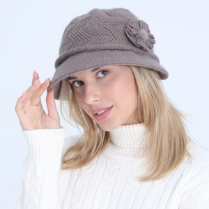 Detail of taupe knitted cloche hat featuring wool texture and elegant 3D flower accent