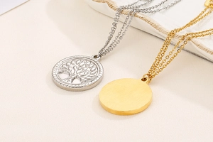 Detail of silver tree of life pendant and gold round pendant on dual layer chains