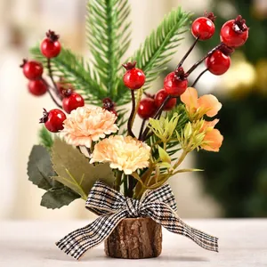 Detail view of mini Christmas tree with red berries, pine needles and a plaid bow