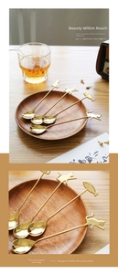 Detailed macro of gold-plated 304 stainless steel spoons featuring cat and fish shapes