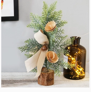 Close-up of 25cm mini pine tree with pine cones, paper flowers, and natural wood base
