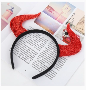 Detailed close-up of red sequined devil horns on a black headband for Halloween