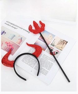 Detail of red sequined devil horn headband and matching trident for Halloween party costume