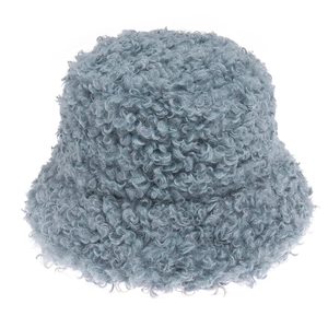Close-up of curly lamb wool texture on a thick gray-blue winter bucket hat for warmth