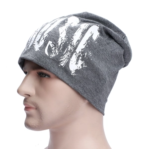 Close-up of deep gray street-style beanie with white graphic print on a model