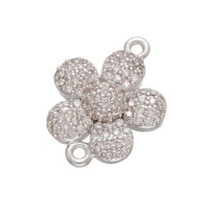 Macro view of micro-pave cubic zirconia flower charm with silver connector loops
