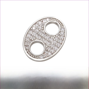 Macro detail of rhodium plated brass pig nose charm with micro-pave cubic zirconia