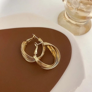 Modern multi-layer twisted gold hoop earrings in a minimalist geometric design for women