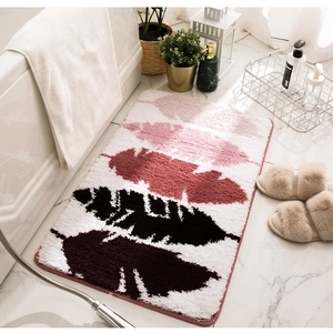 Detail of soft flocked bathroom mat featuring vibrant pink and burgundy leaf patterns
