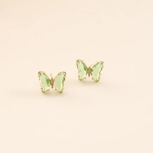 Detail shot of light green butterfly studs with gold frame and micro-zircon accents