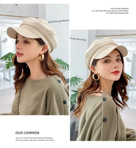 Close-up of beige linen cotton octagonal newsboy cap showing fabric texture and visor
