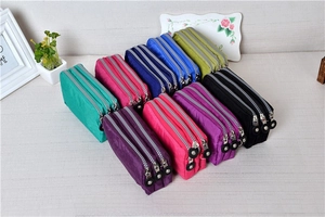 Top view of multi-color triple-zipper washed denim coin pouches with round metal pullers
