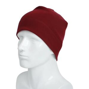 Detail view of burgundy knitted beanie on mannequin head showing fine stitching and fabric
