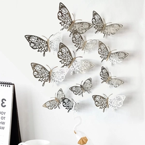 Detailed view of silver and white 3D hollow butterfly wall stickers on a clean white wall