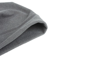 Detail of grey knitted hat showing fine fleece texture and reinforced double stitching