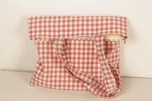 Detail view of pink gingham cotton tote bag featuring a secure top metal zipper closure