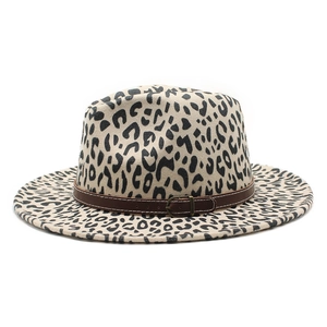 Detail of leopard print fedora hat featuring a brown leather belt with metal buckle