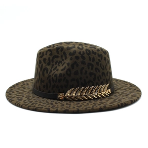 Detailed macro view of leopard print fedora hat with gold leaf and black leather band