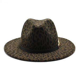 Detail of leopard print fedora hat featuring black leather band and gold metal buckle