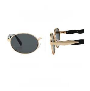 Detailed view of oval sunglasses featuring gold metal frames and geometric temples