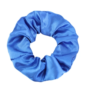 Detail of royal blue satin scrunchie showing glossy silk texture and pleated fabric design