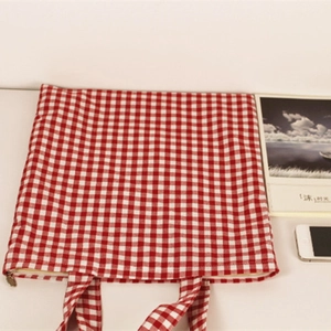 Classic red and white checkered canvas tote bag with shoulder straps and secure zipper