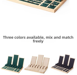 Bamboo jewelry display set showing rings and necklaces in green, beige and black velvet slots