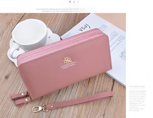 Dusty pink litchi grain faux leather wallet with double zippers and gold clover logo