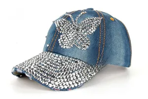 Detail view of denim baseball cap featuring rhinestones butterfly and orange stitching