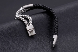 Detail of men's leather cord bracelet with silver spiga chain and magnetic clasp