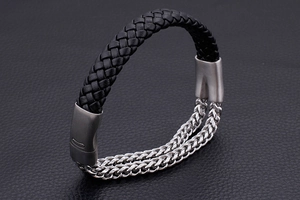 Detail of men's leather braided bracelet with double row metal chains and matte clasp