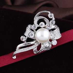 Elegant silver bow brooch with large central pearl and sparkling crystals on red ribbon