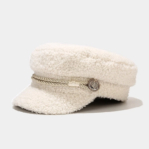 Detail of creamy white lamb wool newsboy cap with gold braided rope and vintage button