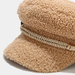 Detail of khaki lamb wool baker boy hat with decorative gold braided cord and plush texture